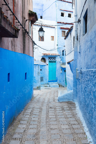 blue street and emerald door in blue city Chefchaouen in Morocco © sergejson