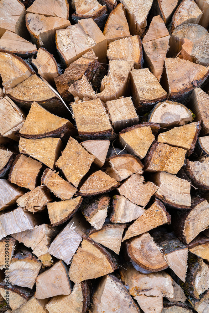 A stack of seasoned firewood logs seen from the front. A stack of seasoned firewood logs seen from the front.