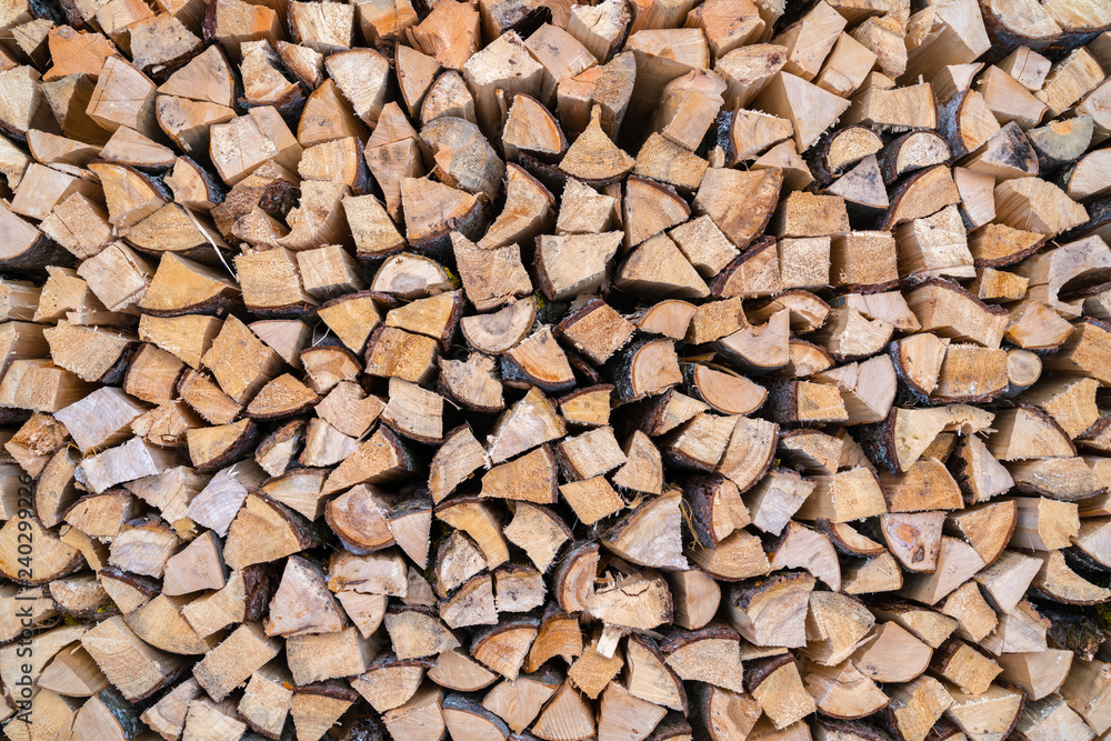 A stack of seasoned firewood logs seen from the front. A stack of seasoned firewood logs seen from the front.