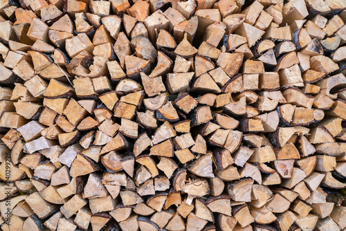 A stack of seasoned firewood logs seen from the front.