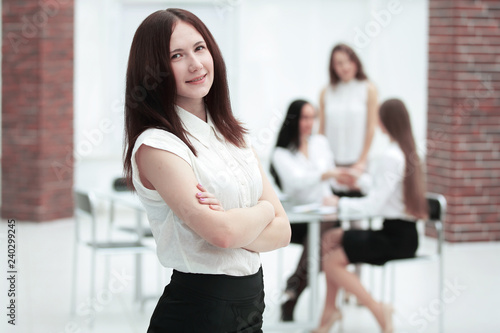 portrait of confident young business woman on office background