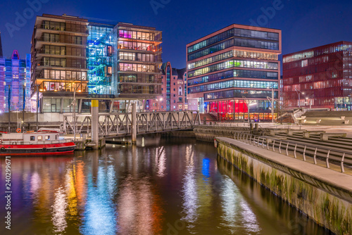 The Harbor District  HafenCity  in Hamburg  Germany  at night. A view of the Sandtorkai and the Magellan-Terassen across the traditional port Sandtorhafen.