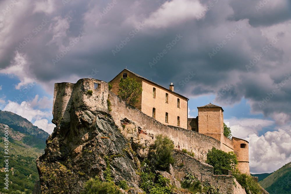 Historical building od Museum in city of Corte in the mountains in Corsica with dramatic cloudy sky