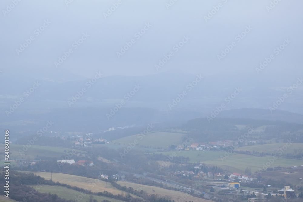 Czech landscape during snowfall viewed from Doubravska hora mountain on 15th december 2018