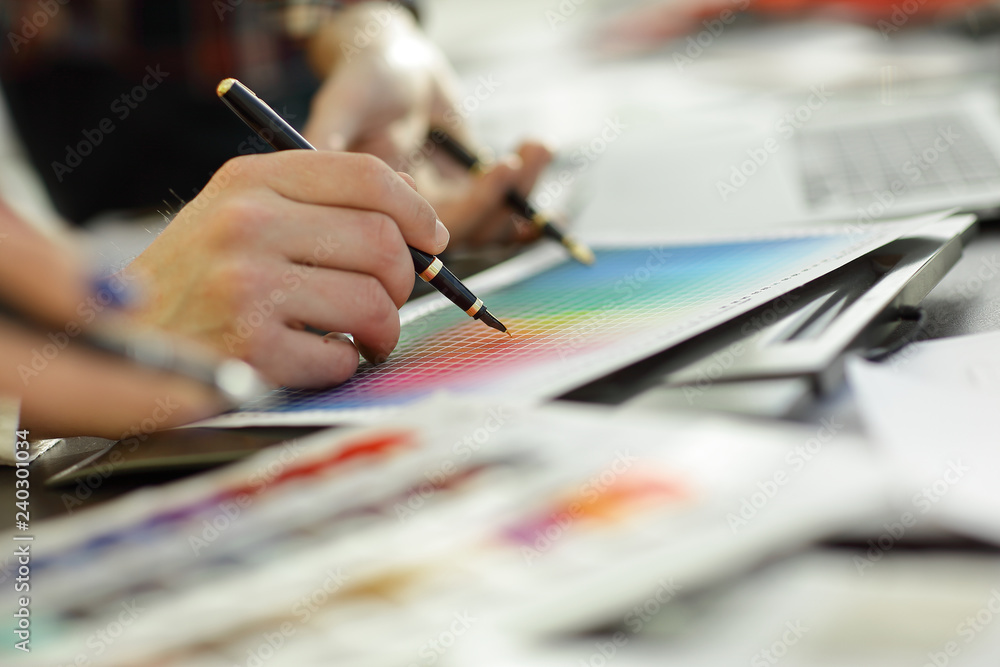 close up.a group of designers discuss the color palette close up.a group of designers discuss the color palette