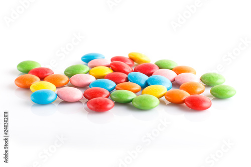 Colorful multicolored chocolate candy dragees isolated on white background.