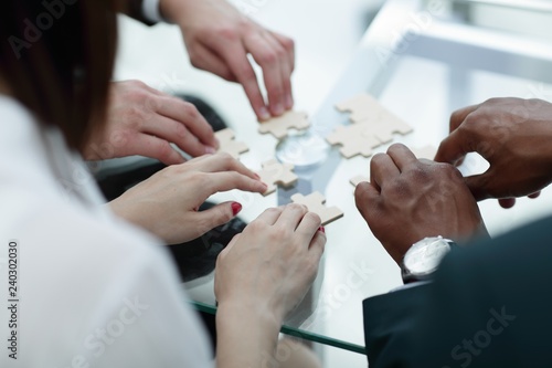 close up. business team assembling puzzle pieces.