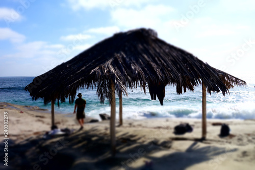 Silhouette of a person meditating at a beach shack in San Diego