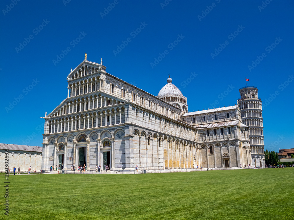 Summer clear blue sky view of Pisa Cathedral and the Leaning Tower in Piazza dei Miracoli or Square of Miracles in Pisa, Italy