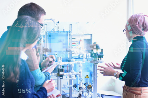 Canvas Print Group of young students  in technical vocational training with young female muslim teacher