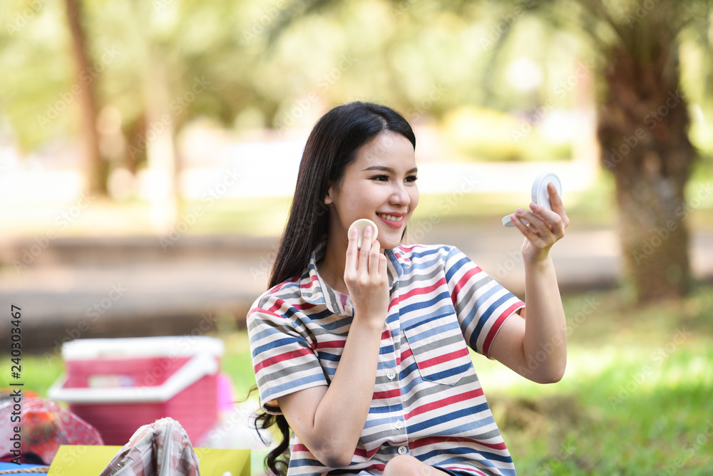Mirror woman Make up cosmetics smiling young girl make up face on outdoors Powder make up woman look at mirror personally Mirror woman Make up cosmetics smiling young girl make up face on outdoors Powder make up woman look at mirror personally
