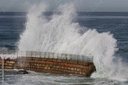 Huge waves crashing over the seawall during storm at La Jolla Cove, San Diego