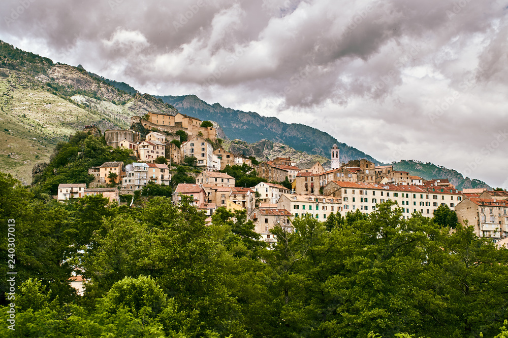Panoramic view of Corte city in Corsica with dramatic sky clouds