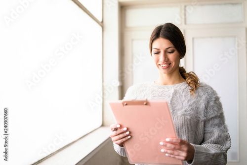 secretary checking schedule on clipboard