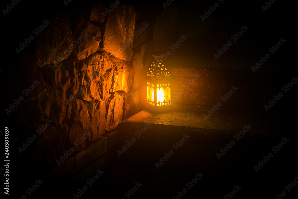 Beautiful colorful illuminated lamp in the garden in misty night. Retro style lantern at night outdoor. Beautiful colorful illuminated lamp in the garden in misty night. Retro style lantern at night outdoor.