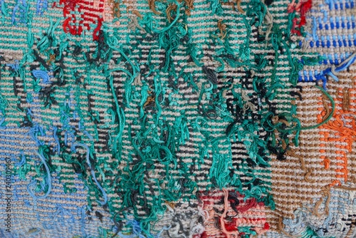 colored fabric texture of embroidered threads on a piece of old clothes with a pattern