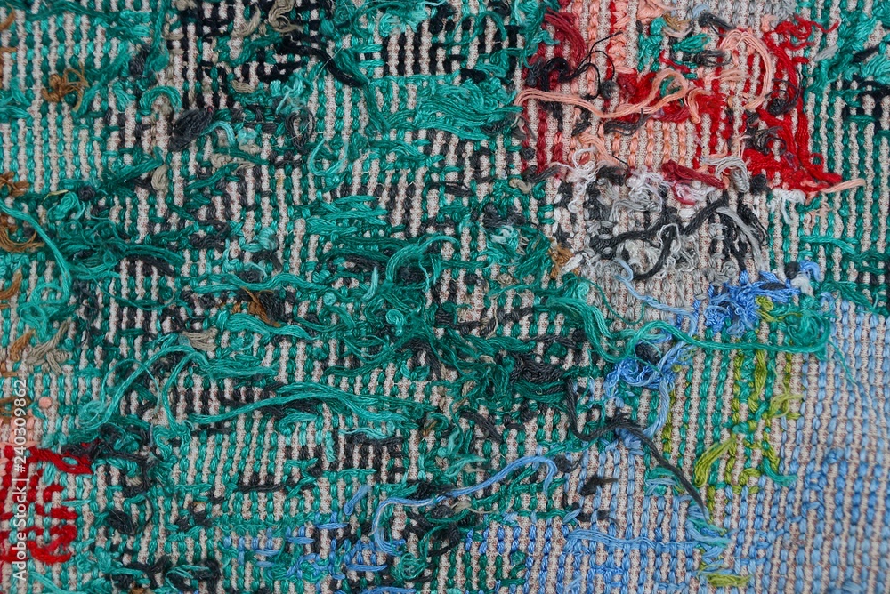 colored fabric texture from embroidered threads on a piece of old clothes