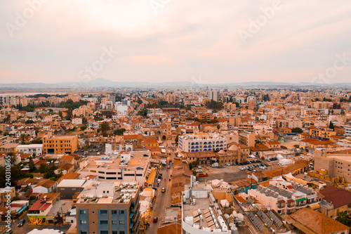 Aerial bird's eye view of Zygi fishing village port, Larnaca, Cyprus. Purple sunset view over the city. photo