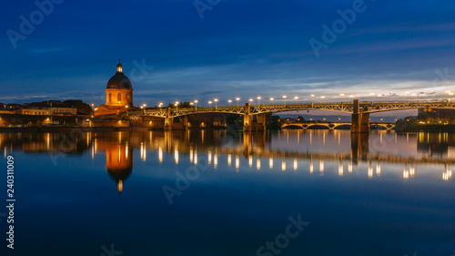 Garonne River at night, with reflections of Saint-Pierre Bridge and Chapel of hôpital Saint-Joseph de la Grave, in Toulouse, France