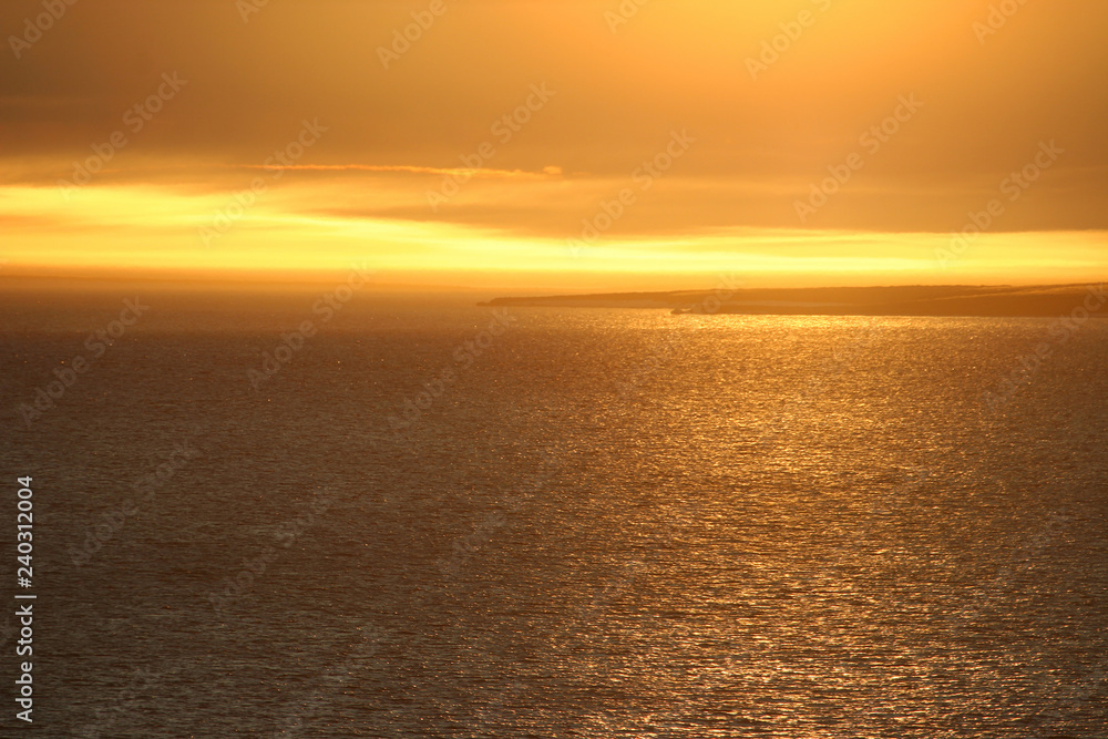 Fototapeta premium Beautiful golden sunset over the Anadyr estuary. View of the Thin Cape. Chukotka, Siberia, the Far East of Russia. Photo can be used for background.