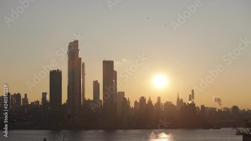 timelaps motion win sunrise over Manhattan photo