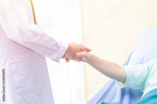 Doctor routine health and holding hands of patient.