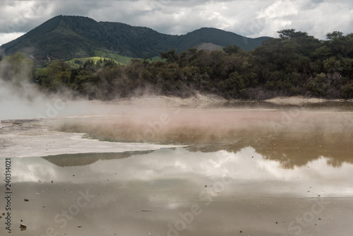 Reflections on the calm surface of the Artist's Palette at the Wai-O-Tapu geothermal area near Rotorua, New Zealand.