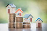 Mini house on stack of coins,Money and house,  Mortgage, Savings money for buy house and loan to business investment for real estate concept. Invesment and Risk Management, hourglass.