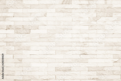 Cream colors and white brick wall art concrete or stone texture background in wallpaper limestone abstract paint to flooring and homework/Brickwork or stonework clean grid uneven interior rock old.