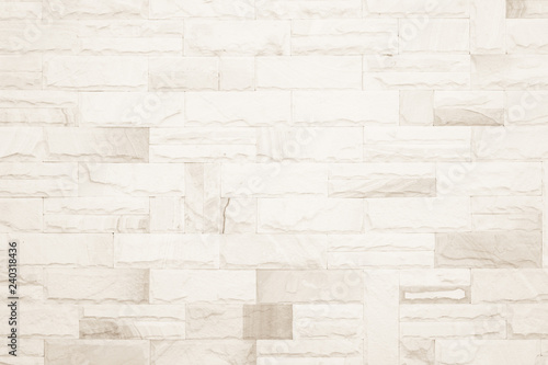 Cream colors and white brick wall art concrete or stone texture background in wallpaper limestone abstract paint to flooring and homework/Brickwork or stonework clean grid uneven interior rock old.