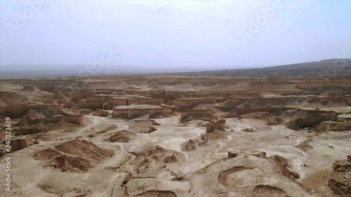 Aerial view of the Judean desert located on the West Bank of the Jordan river. Deserted shore of dead sea. The background of desert. Sandy stony canyon in the desert. A barren land. Midbar Yehuda. 4k photo