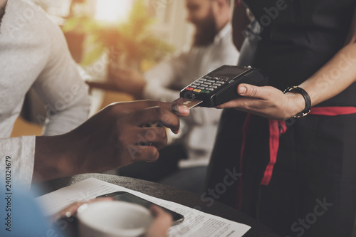 Young African American is calculated credit card