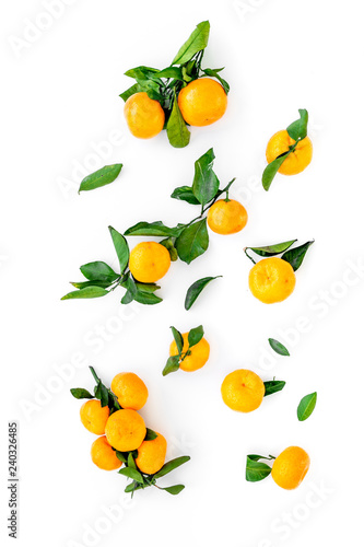 Fototapeta Naklejka Na Ścianę i Meble -  Winter fruits for New Year and Christmas. Tangerines on white background top view