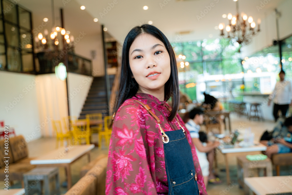 Confident business entrepreneur smiling women standing with coffee shop background Confident business entrepreneur smiling women standing with coffee shop background