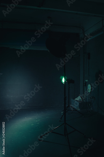 Several reflectors on the black background in photo studio. Preparing for professional shooting