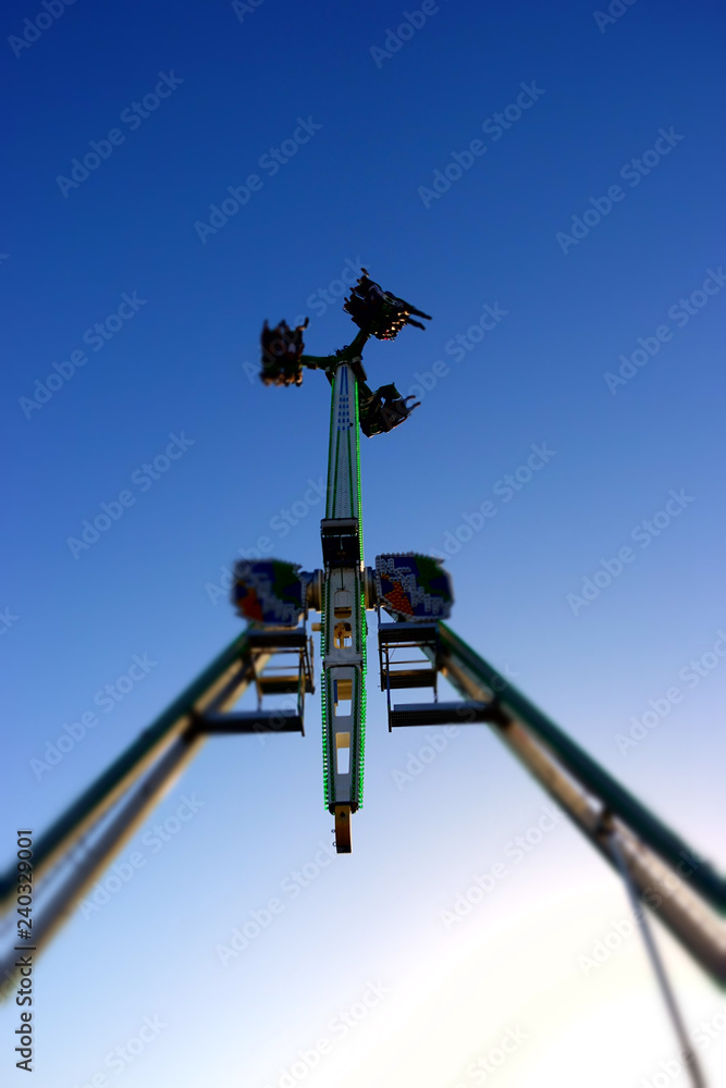 Silhouette of people on a carnival ride at the County Fair at dusk Silhouette of people on a carnival ride at the County Fair at dusk