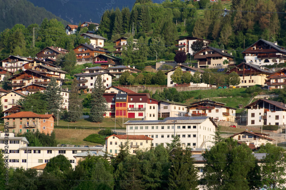 Domegio di Cadore, Italy August 11, 2018: Beautiful buildings in a mountain village at sunrise.