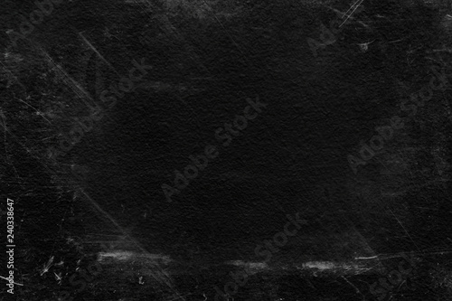 Old black stucco wall with white scratches and scuffs texture. textured grunge black board with chalk