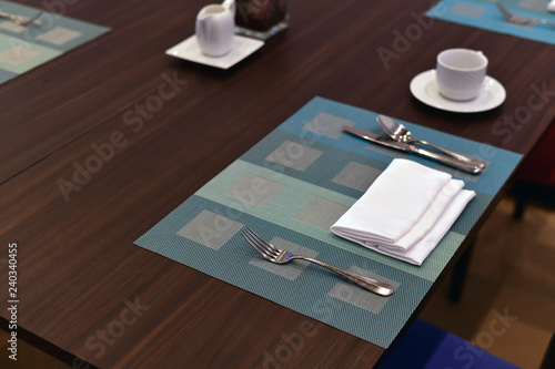 Cafe tables served with cutlery and tea pair