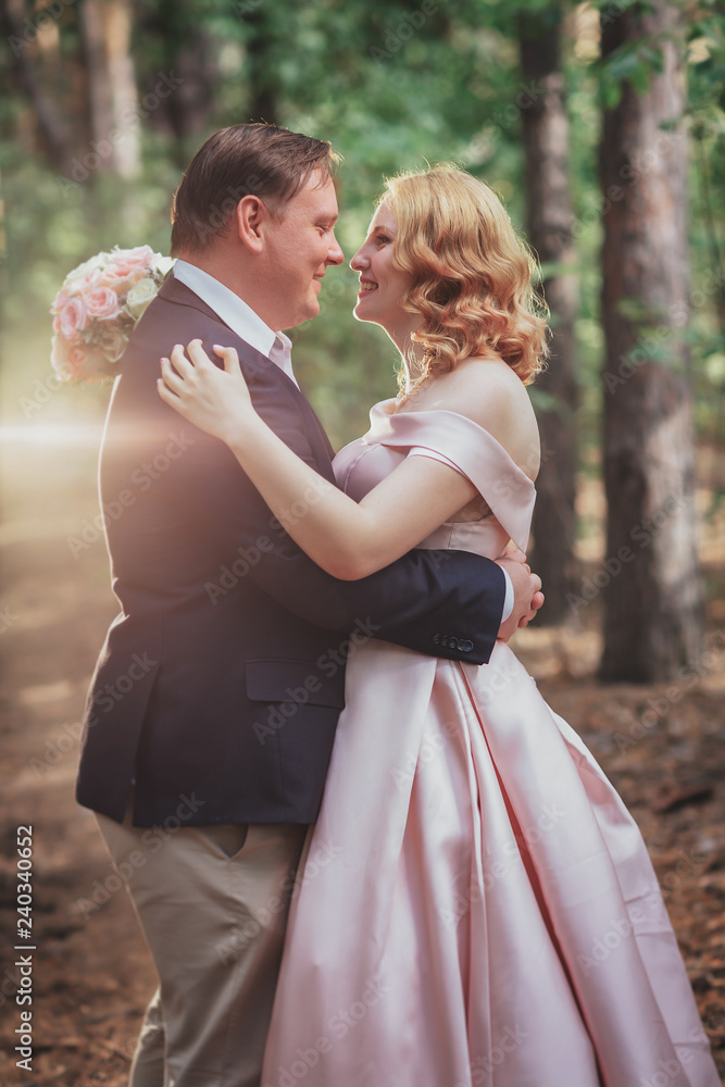 bride and groom on the background of trees and forest sun bride and groom on the background of trees and forest sun