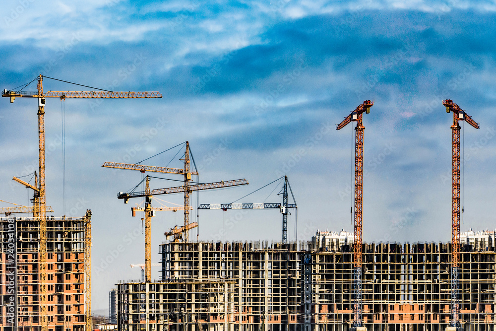 Construction of new residential buildings against the sky . The concept of the construction business . Construction of new residential buildings against the sky . The concept of the construction business .