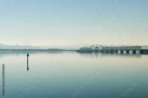 A bridge over the Coos River bay at its mouth next to the Oregon Dunes