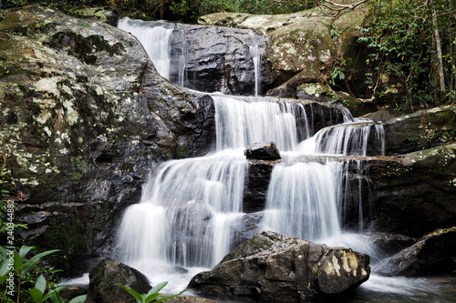 Mountain river background with small waterfalls in tropical forest.