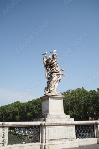 Marble statue by Bernini on the Bridge of Angels  Rome  Italy  with two seagulls sitting on its head