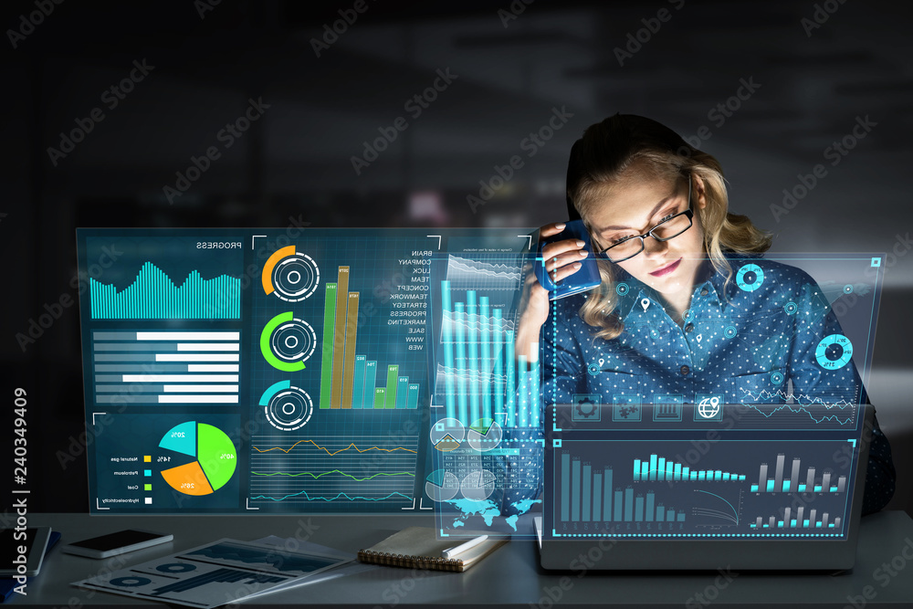 Beautiful blonde working on laptop and infographs out of screen. Mixed media