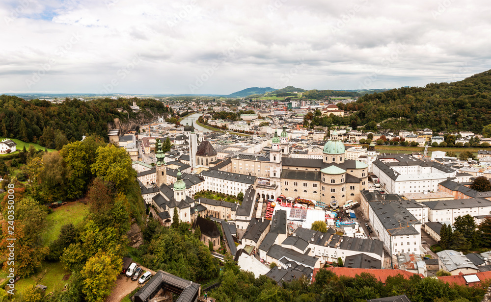 Salzburg city panorama with old and new city divided by river Salznach on summertime.