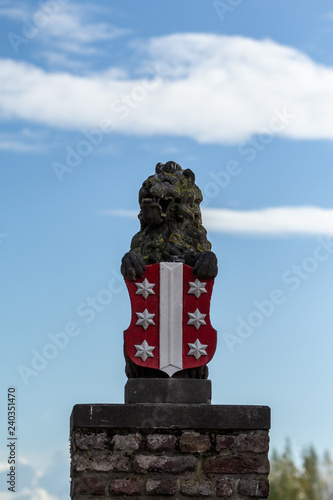 Gouda, South-Holland/The Netherlands - October 27 2018: Lion statue holding Gouda city emblem located at the Veerstal portrait mode photo