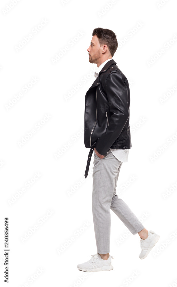 Side view of going handsome man in a leather jacket and trouser Side view of going handsome man in a leather jacket and trouser