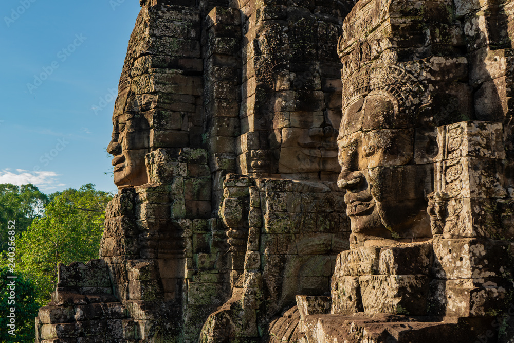 Fototapeta premium Smiling stone faces of bayon temple in cambodia