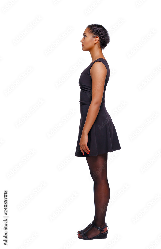 Fototapeta premium Side view of an African-American woman in a brown dress.
